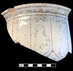 Chamberpot with loop motif.  Arches, scallops, loops and lobes, used in conjunction with vertical panels, became common on white granite in the 1850s (Wetherbee 1996:81). This vessel has been overfired and the bubbled glaze is particularly apparent in the outline of the loops.  Rim diameter: 9.50”, Vessel #: 99. 18BC56